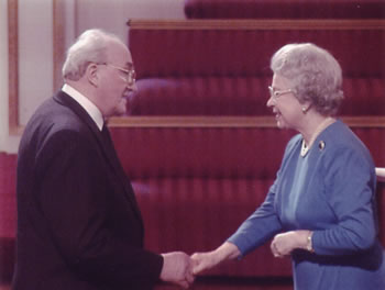 Desmond C. Henley and Her Majesty at Buckingham Palace